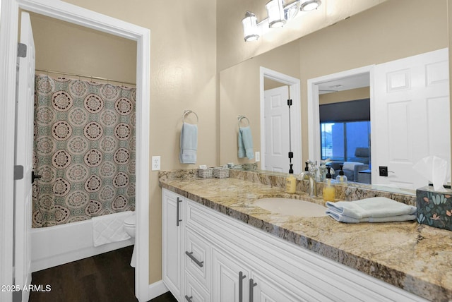 full bathroom with vanity, wood-type flooring, shower / bath combination with curtain, and toilet