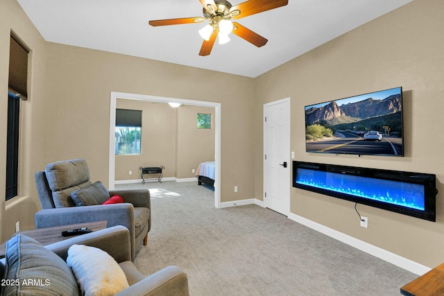 living room featuring ceiling fan and carpet