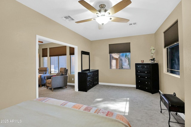 carpeted bedroom with ceiling fan and multiple windows