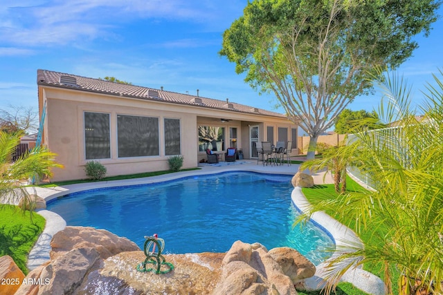 view of swimming pool featuring a patio area and ceiling fan