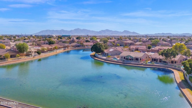 birds eye view of property with a water and mountain view