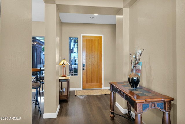 entryway with dark hardwood / wood-style flooring