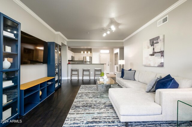 living room featuring crown molding and dark wood-type flooring