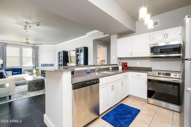 kitchen featuring kitchen peninsula, stainless steel appliances, sink, white cabinets, and light tile patterned flooring