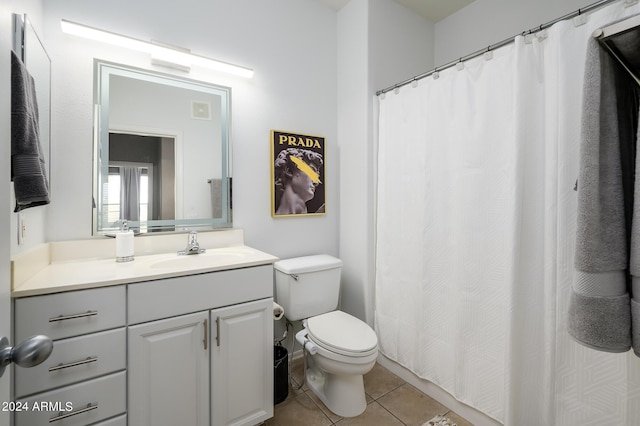 bathroom featuring tile patterned flooring, vanity, and toilet