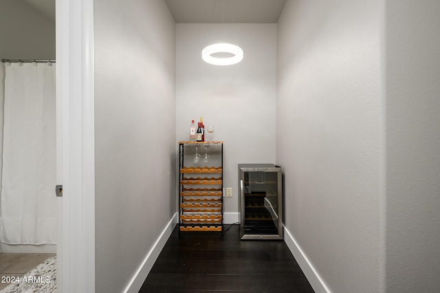 hall with beverage cooler and dark hardwood / wood-style floors