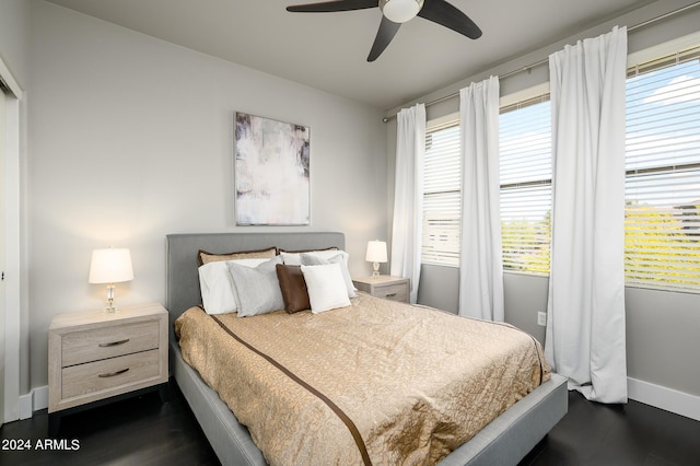 bedroom with dark hardwood / wood-style flooring and ceiling fan