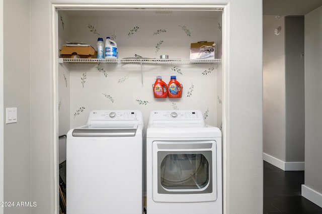 clothes washing area featuring separate washer and dryer and hardwood / wood-style flooring