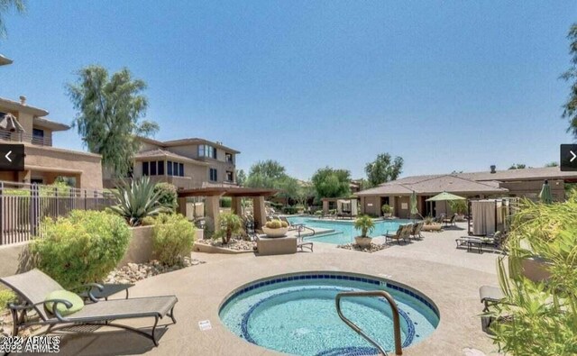 view of pool with a community hot tub