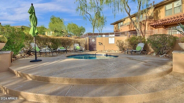 view of pool with a patio and a hot tub