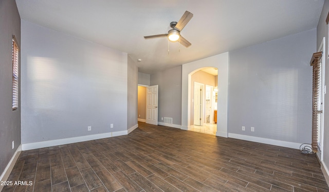 unfurnished bedroom featuring ceiling fan, connected bathroom, and dark hardwood / wood-style flooring