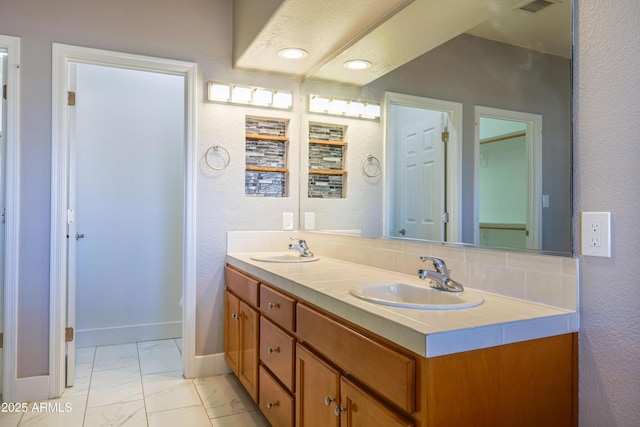 bathroom featuring tasteful backsplash and vanity