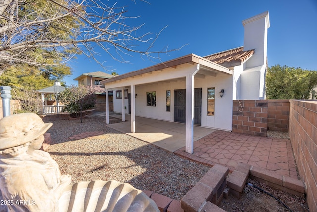 rear view of property featuring a patio