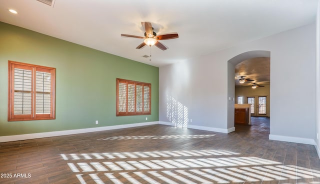 spare room featuring dark wood-type flooring and ceiling fan