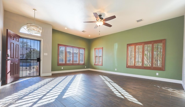 interior space with dark hardwood / wood-style flooring and ceiling fan with notable chandelier