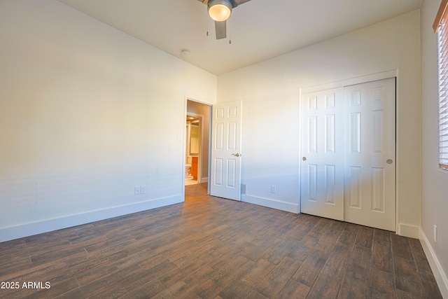 unfurnished bedroom with dark wood-type flooring, ceiling fan, and a closet