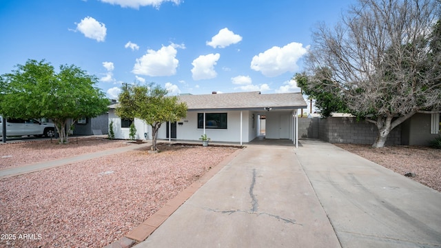 1838 E Earll Dr, Phoenix, AZ 85016 - single story home featuring a carport, a porch, concrete driveway, fence, and stucco siding