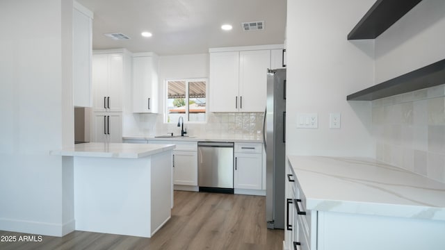 1838 E Earll Dr, Phoenix, AZ 85016 - kitchen featuring appliances with stainless steel finishes, a sink, visible vents, and light wood-type flooring