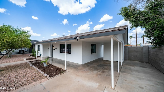 1838 E Earll Dr, Phoenix, AZ 85016 - view of front facade with stucco siding, an attached carport, fence, and concrete driveway