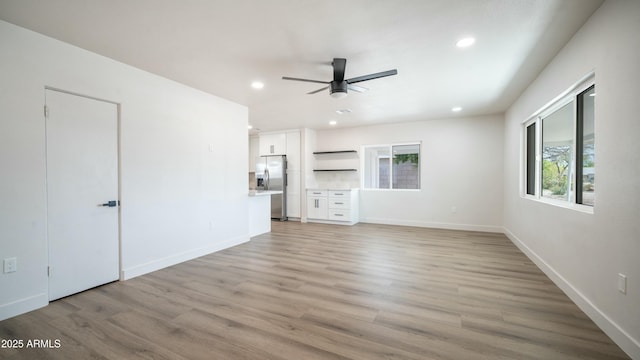 1838 E Earll Dr, Phoenix, AZ 85016 - unfurnished living room with ceiling fan, recessed lighting, baseboards, and light wood-type flooring