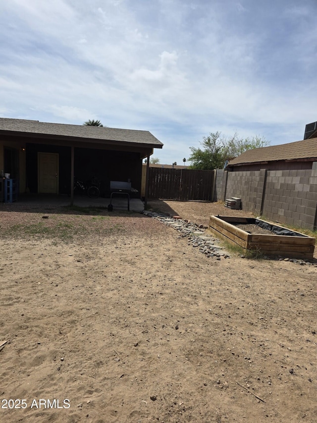 view of yard with central air condition unit, fence, a patio, and a vegetable garden