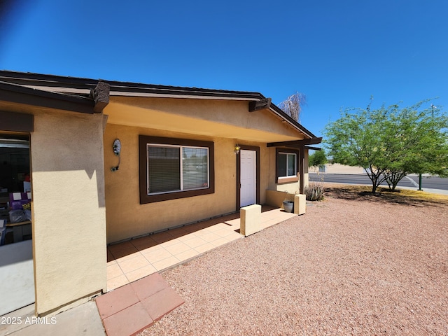back of house with a patio area and stucco siding