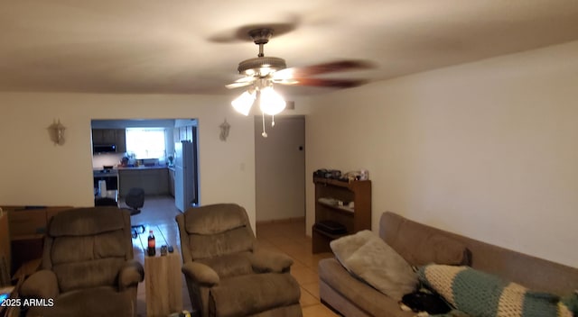 living area with tile patterned floors and a ceiling fan