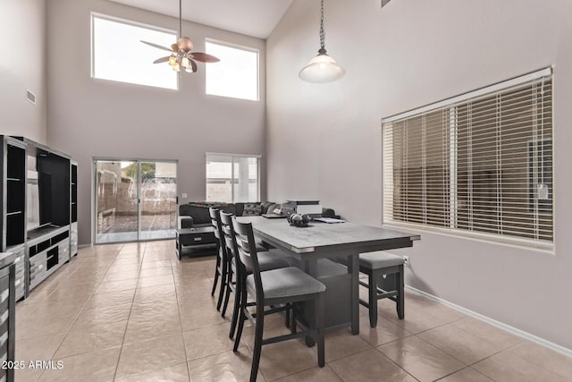 dining space with light tile patterned floors and ceiling fan