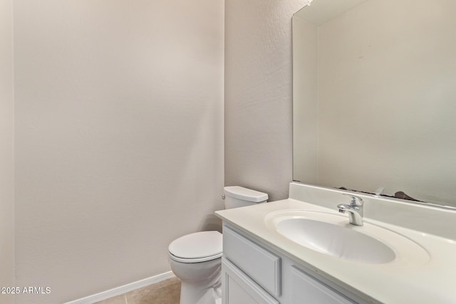 bathroom featuring vanity, tile patterned floors, and toilet