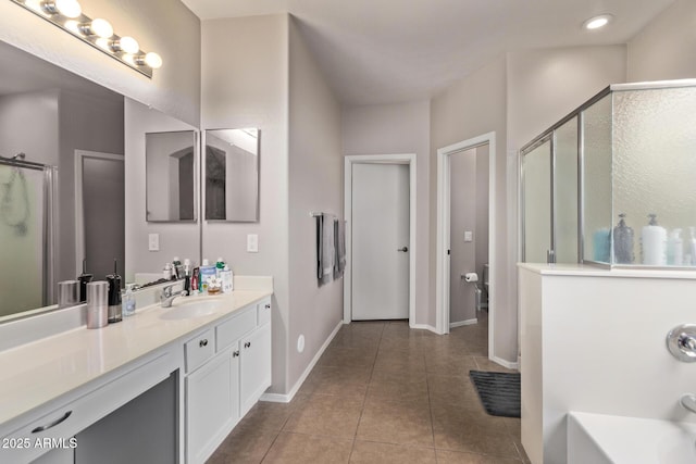 bathroom with vanity, an enclosed shower, and tile patterned flooring