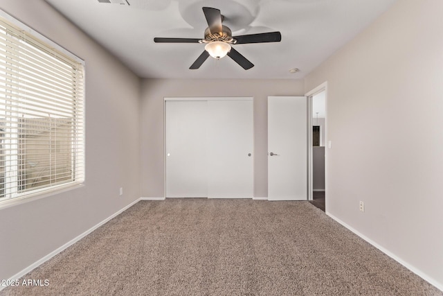 empty room featuring carpet floors and ceiling fan