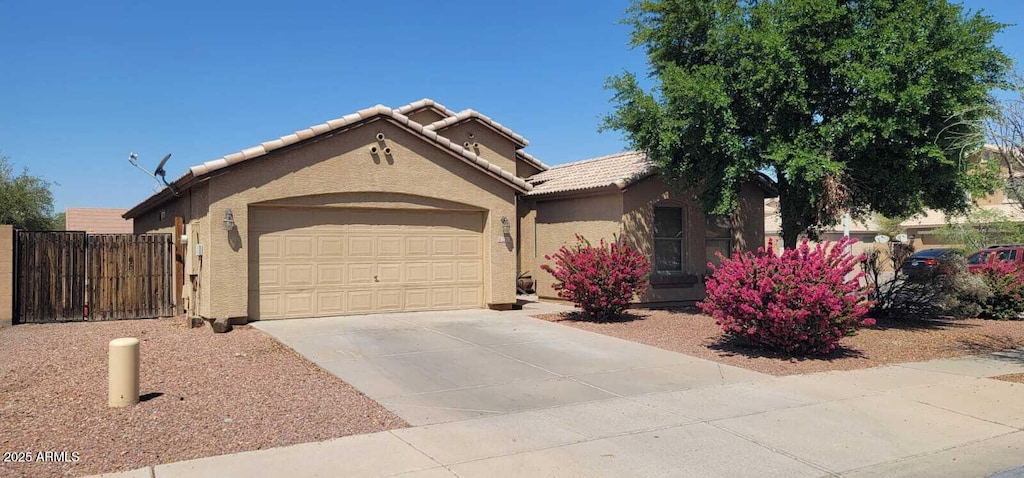 2202 S 82nd Ave, Phoenix, AZ 85043 - view of front facade with an attached garage, stucco siding, concrete driveway, and a tiled roof