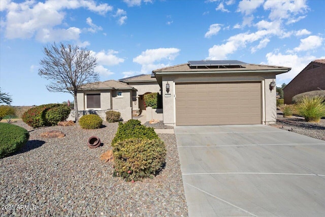 ranch-style house featuring a garage and solar panels