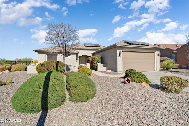 ranch-style home featuring a garage and solar panels