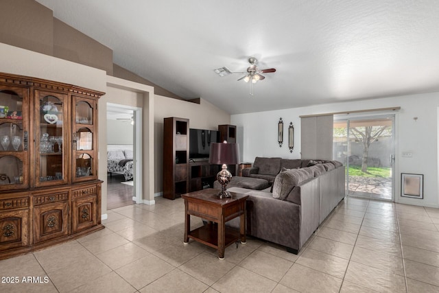 living room with a ceiling fan, visible vents, vaulted ceiling, and light tile patterned floors