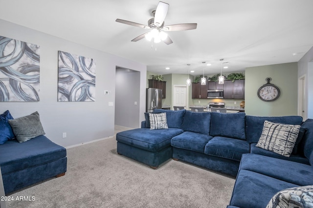 carpeted living room featuring ceiling fan