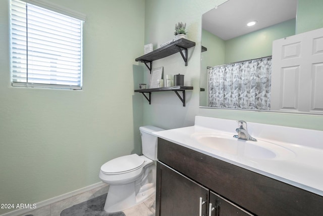 bathroom featuring vanity, toilet, and tile patterned floors