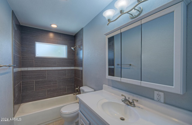 full bathroom with vanity, toilet, and tiled shower / bath combo