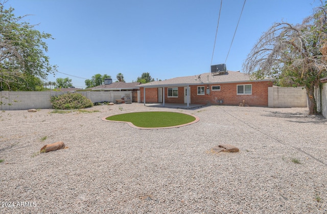 back of house with cooling unit and a patio