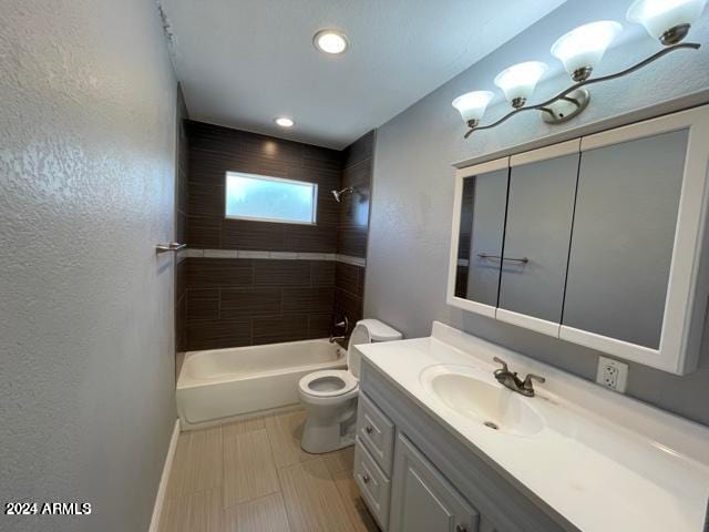 full bathroom with tiled shower / bath combo, vanity, and toilet