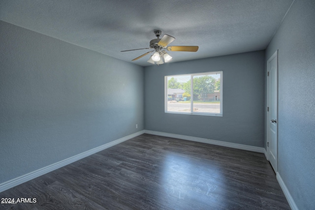 spare room with a textured ceiling, ceiling fan, and dark hardwood / wood-style floors