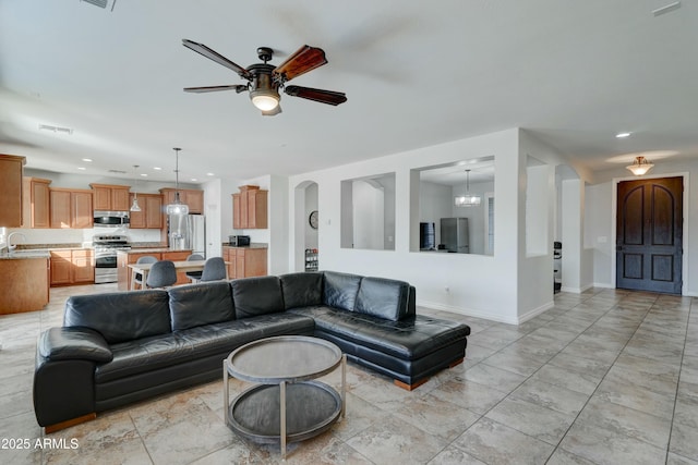 living room featuring sink and ceiling fan