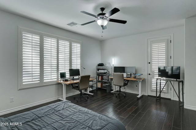 home office with plenty of natural light and ceiling fan