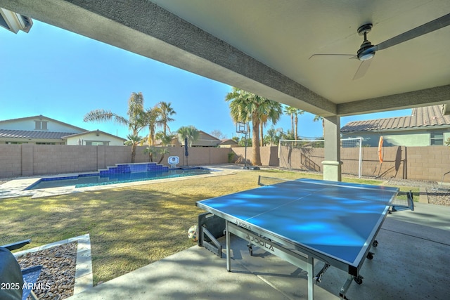 view of patio featuring a fenced in pool and ceiling fan