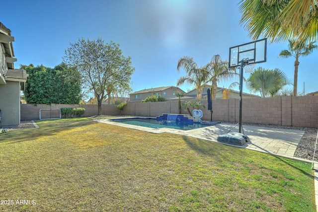 view of yard with a fenced in pool and a patio