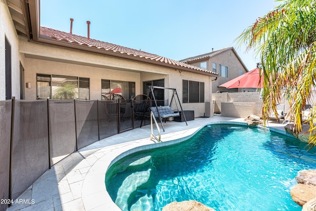 view of swimming pool featuring a fenced in pool, a patio, and fence