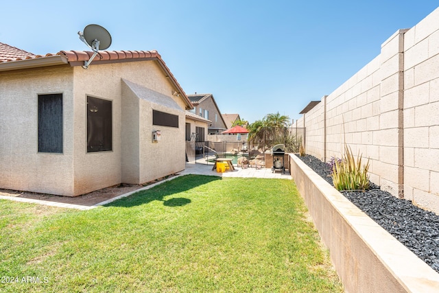 view of yard featuring a patio area and a fenced backyard