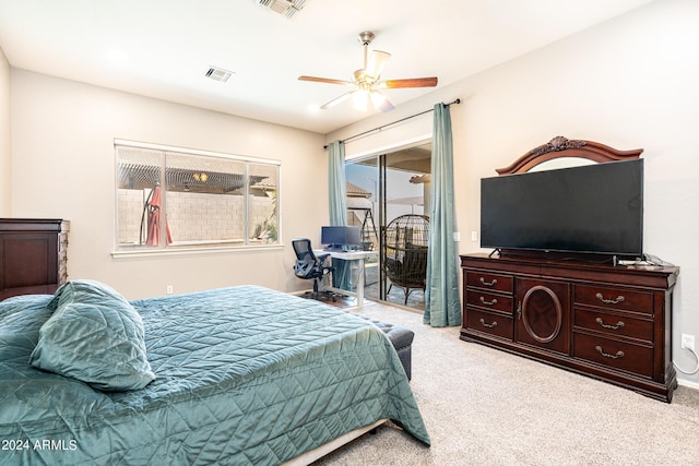 bedroom featuring visible vents, light colored carpet, a ceiling fan, and access to outside