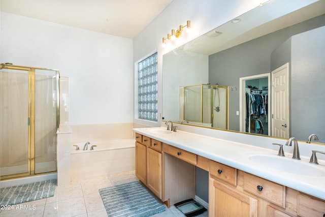 full bathroom featuring tile patterned flooring, a shower stall, a bath, and a sink