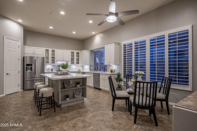 kitchen featuring light countertops, open shelves, white cabinets, and appliances with stainless steel finishes